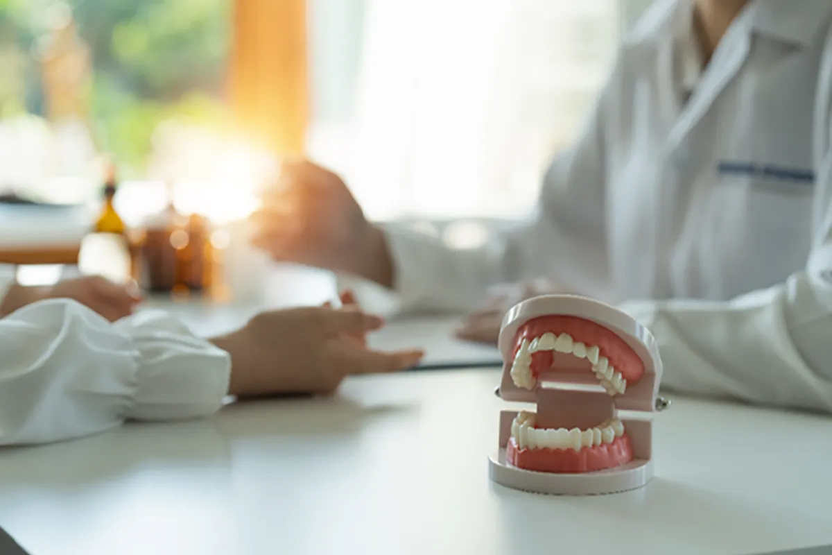 Dentist sitting with another dentist at a desk