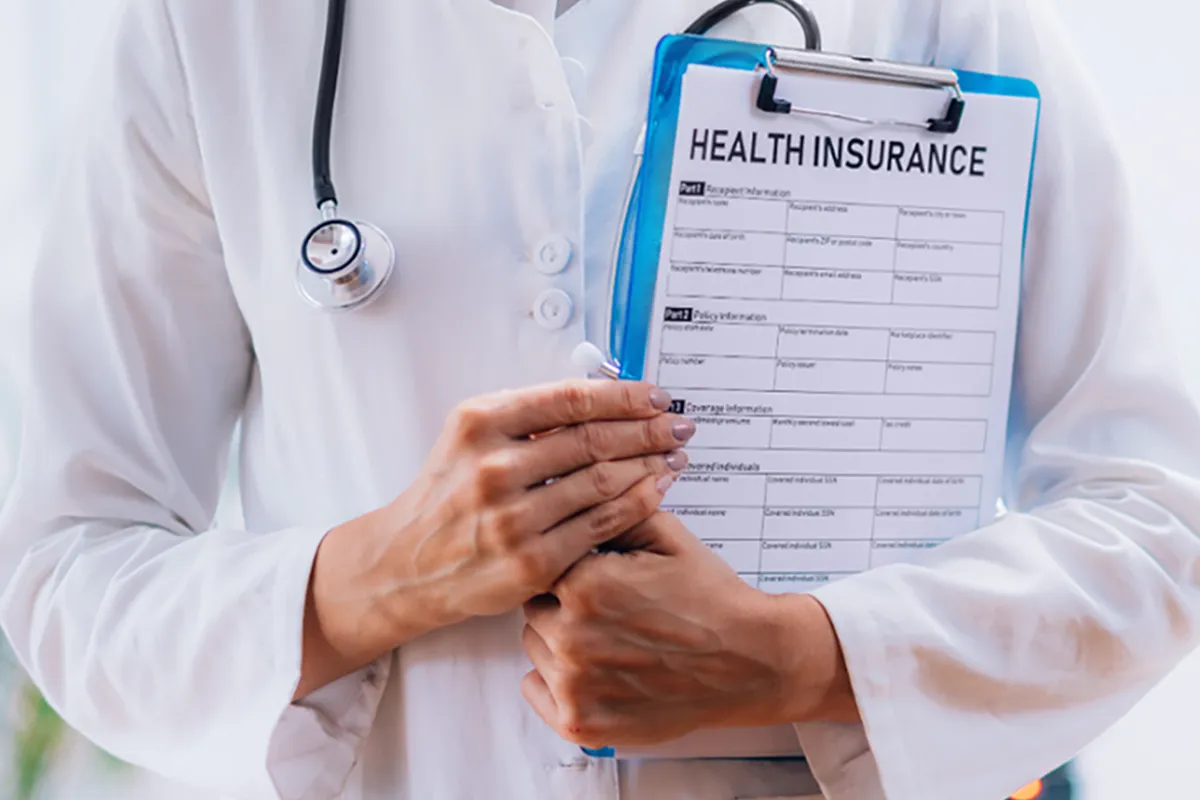 Dentist holding a clipboard with a Health Insurance application