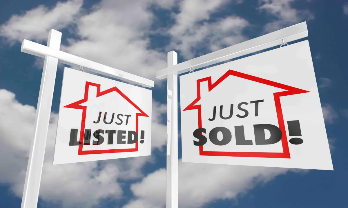Real estate for sale sign and just sold sign