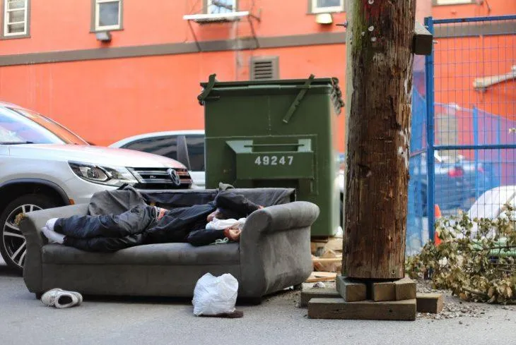 A man sleeps on the street