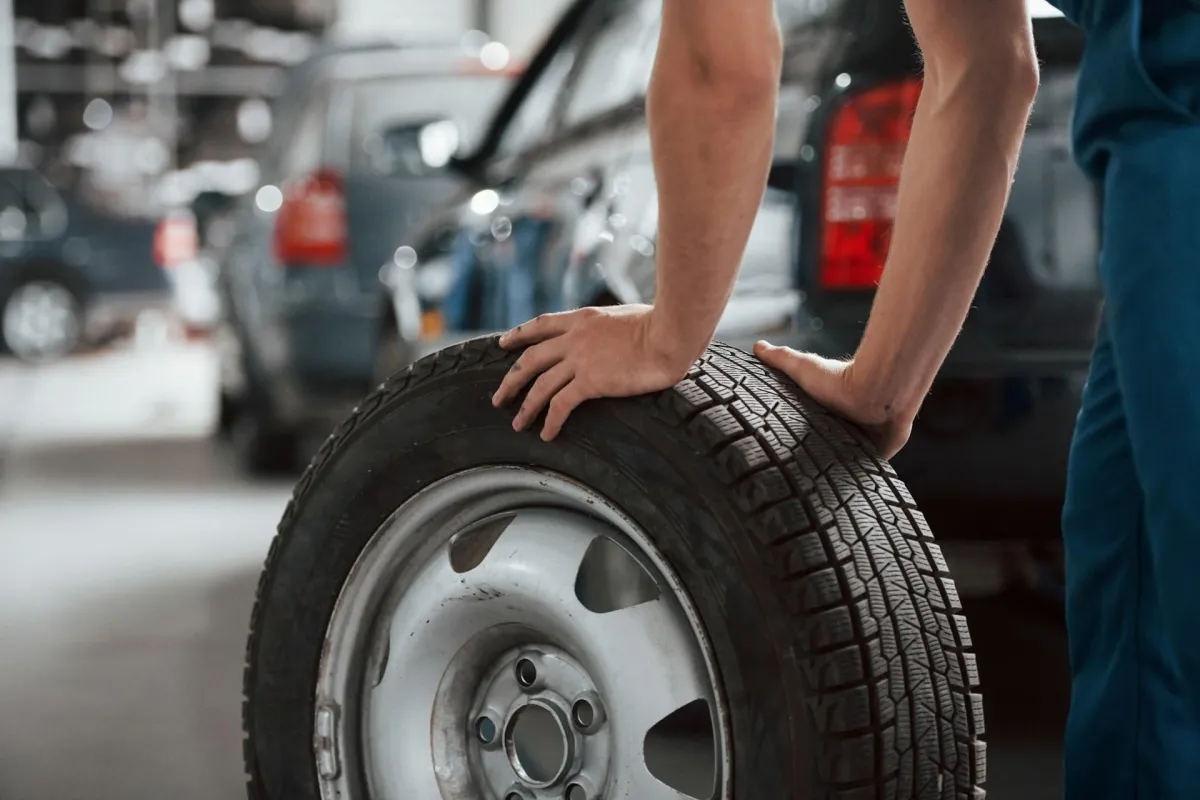 employee holding a tyre