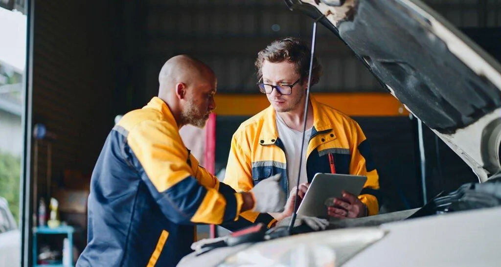 car mechanic checking car battery