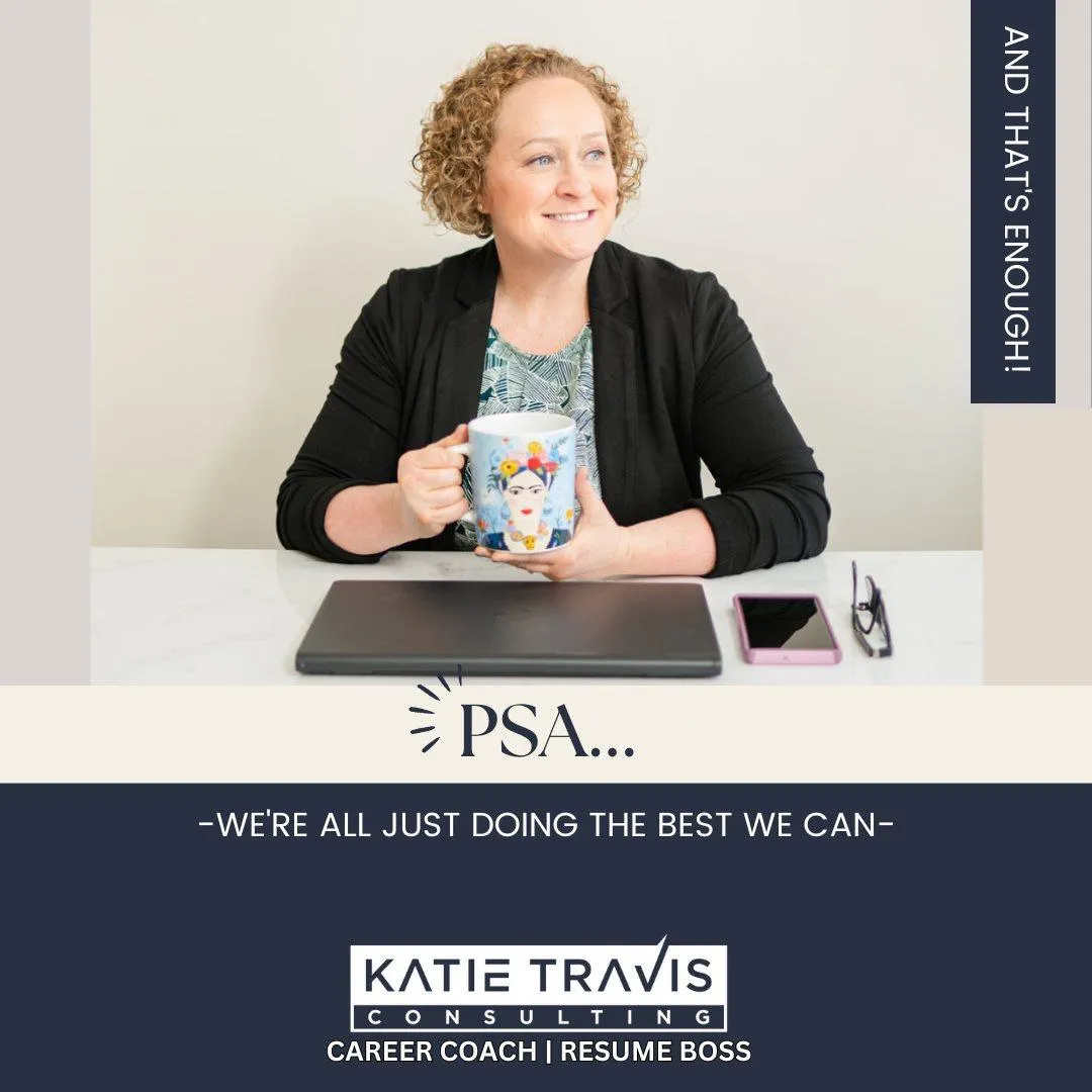 A smiling woman with curly hair sits at a desk holding a colorful Frida Kahlo-themed coffee mug. She wears a black blazer over a patterned blouse. A laptop, pink phone, and glasses rest on the desk. The text on the image reads, "PSA... We're all just doing the best we can." A vertical banner states, "And that's enough!" The branding at the bottom reads, "Katie Travis Consulting - Career Coach | Resume Boss.