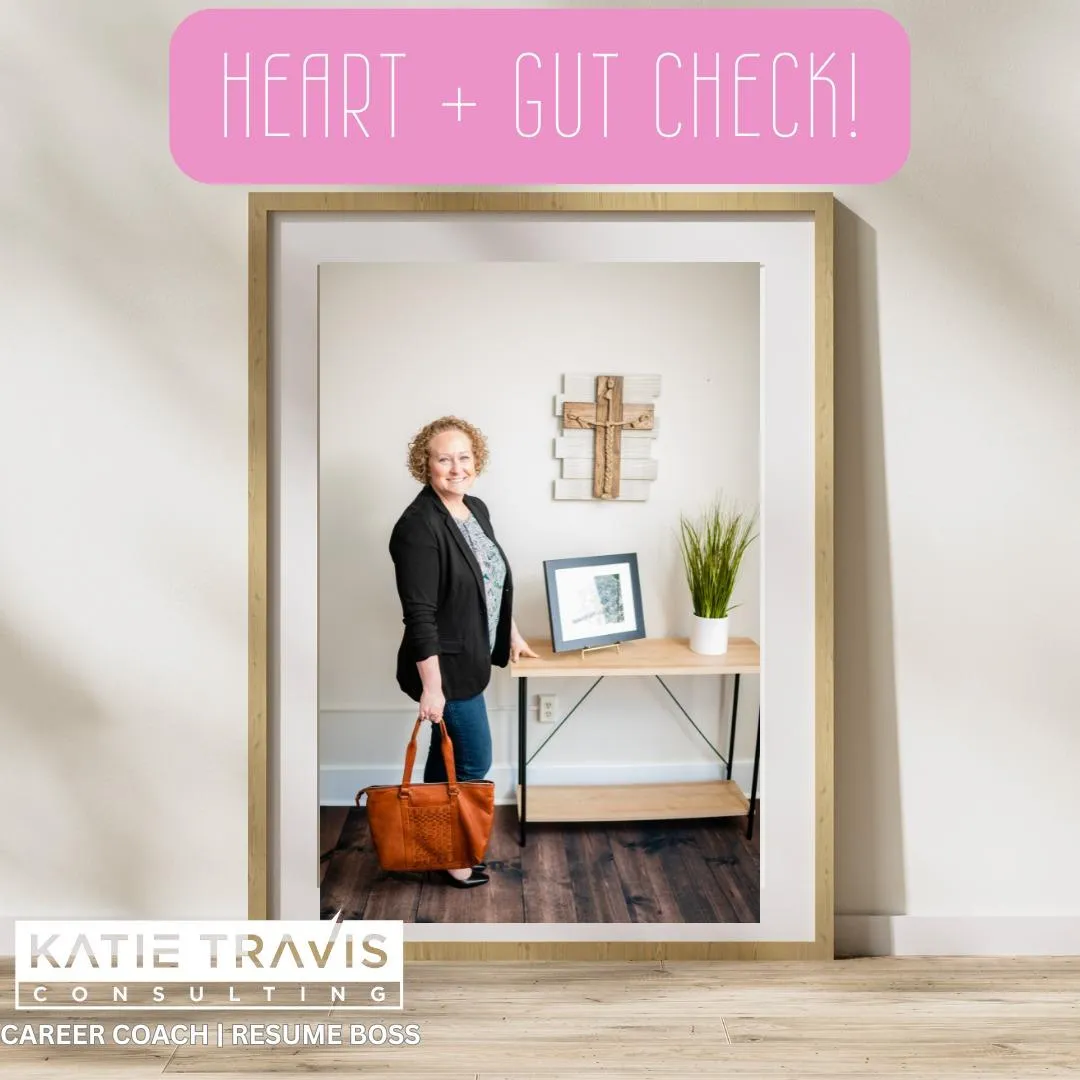 A framed photo of a smiling woman standing in a modern office space with a wooden desk, potted plant, and wall cross. She carries a brown leather handbag and wears a black blazer over a patterned blouse. The image includes the text 'Heart + Gut Check!' in pink and 'Katie Travis Consulting - Career Coach | Resume Boss' in white.