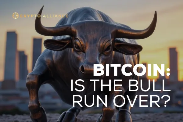 A metal bull statue with a city backdrop behind it