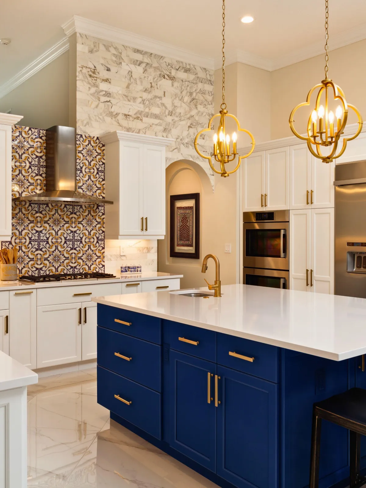 Modern kitchen remodel featuring white shaker cabinets, a striking blue island centerpiece, and elegant gold accents for a luxurious finish.