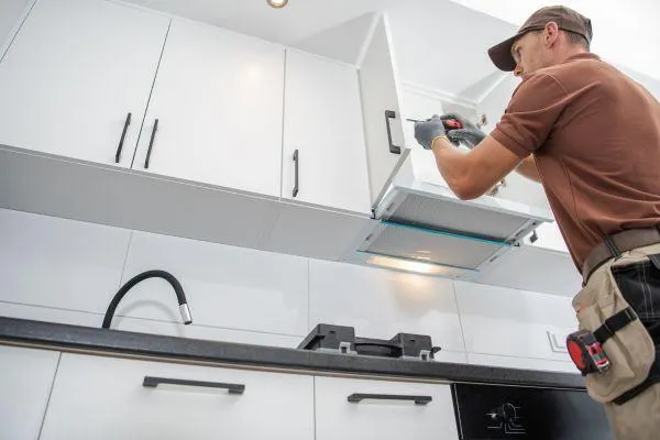 custom cabinets install white shaker black handles accessories and handy man drilling them in.  