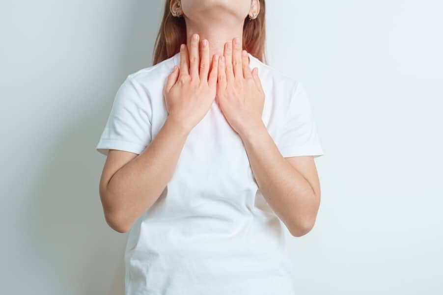 Woman touching her throat