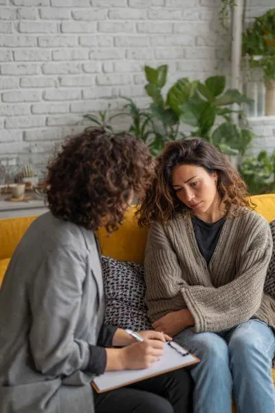 Counsellor supporting a woman in distress during a trauma therapy session, symbolising emotional healing and compassionate trauma counselling in Johannesburg