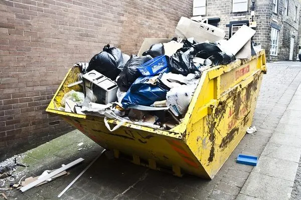A junk bin in an alley