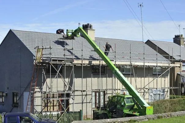 Roofing company working on a home.
