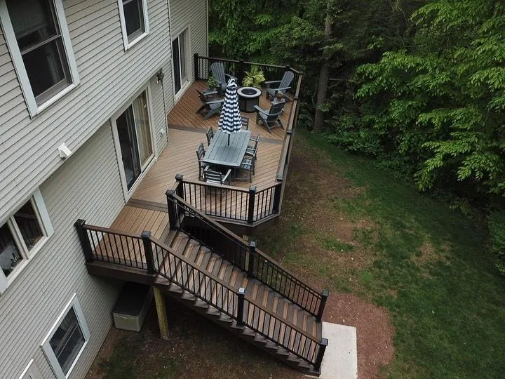 Multi-level backyard deck with stairs and outdoor dining set - deck building by Prime Decks in Wilmington, DE