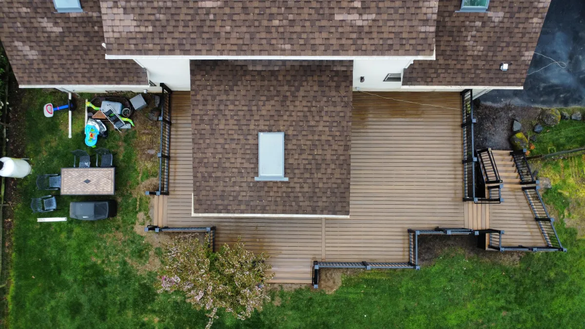 Top-down aerial view of a composite deck wrapping around a home - deck building by Prime Decks in Pike Creek, DE