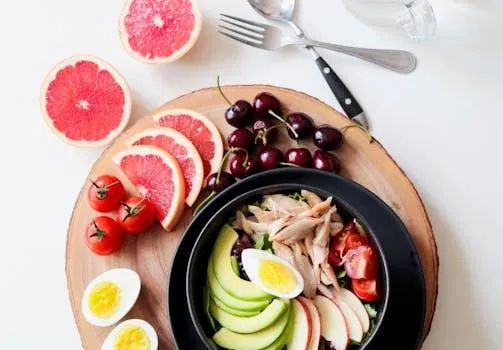 Plate of fruits, vegetables and proteins ready to eat.