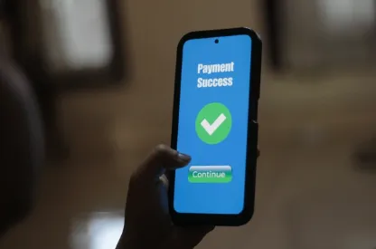 A smartphone screen displays a successful mobile payment confirmation with a bold green checkmark and “Payment Success” message.