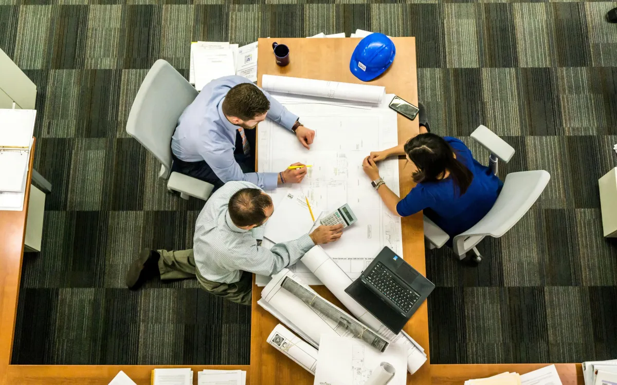 A group of employees sitting around a table discussing HR operations