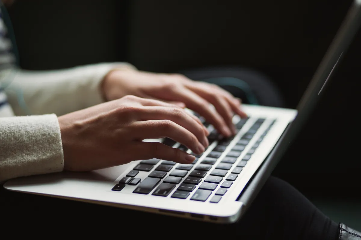 person typing on their computer