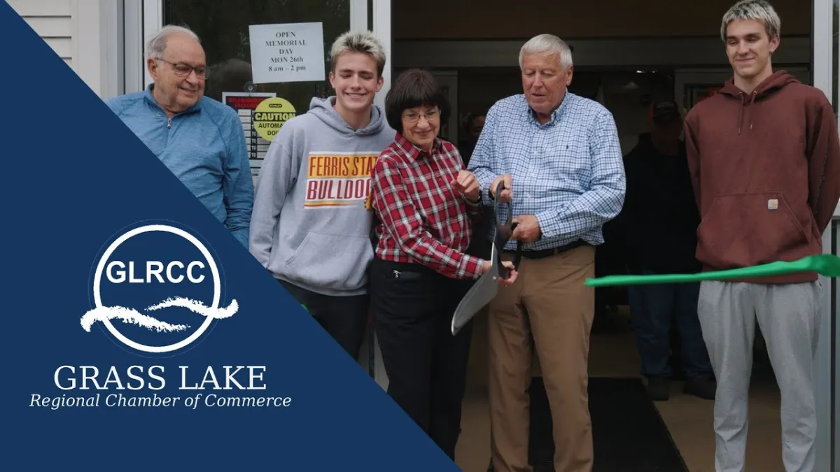 Jim and Diane Cutting ribbon with Grandsons
