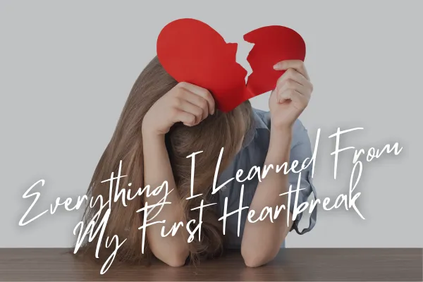 girl holding a heartbreak sign