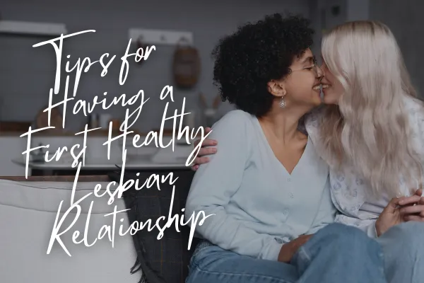lesbian couple kissing on couch