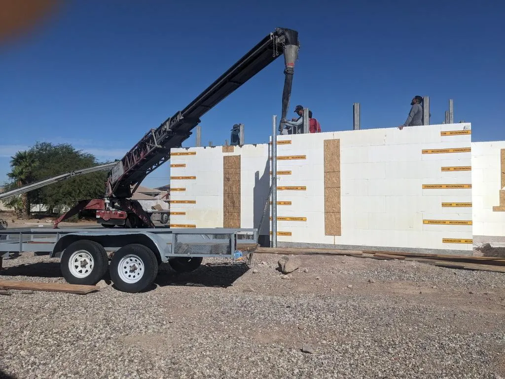 Concrete vibrator being used properly in ICF wall with brief insertion technique