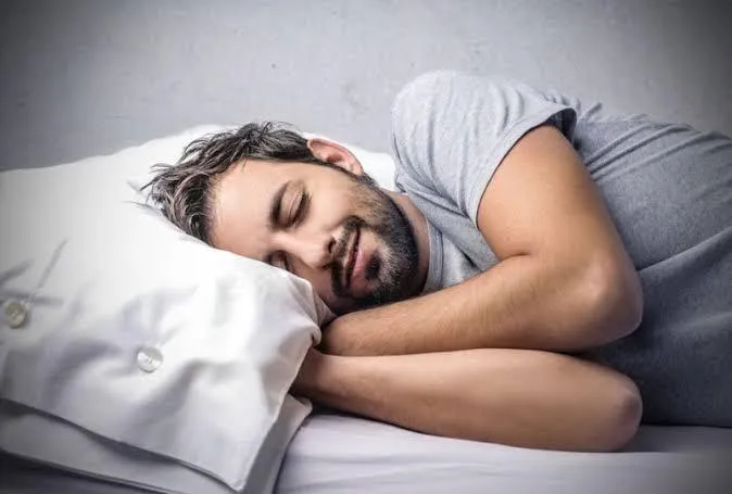 Man asleep on his bed