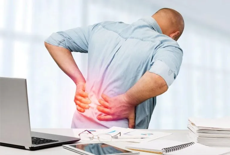 Man clutching inflamed lower back