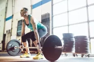 Woman doing strength training by lifting weights