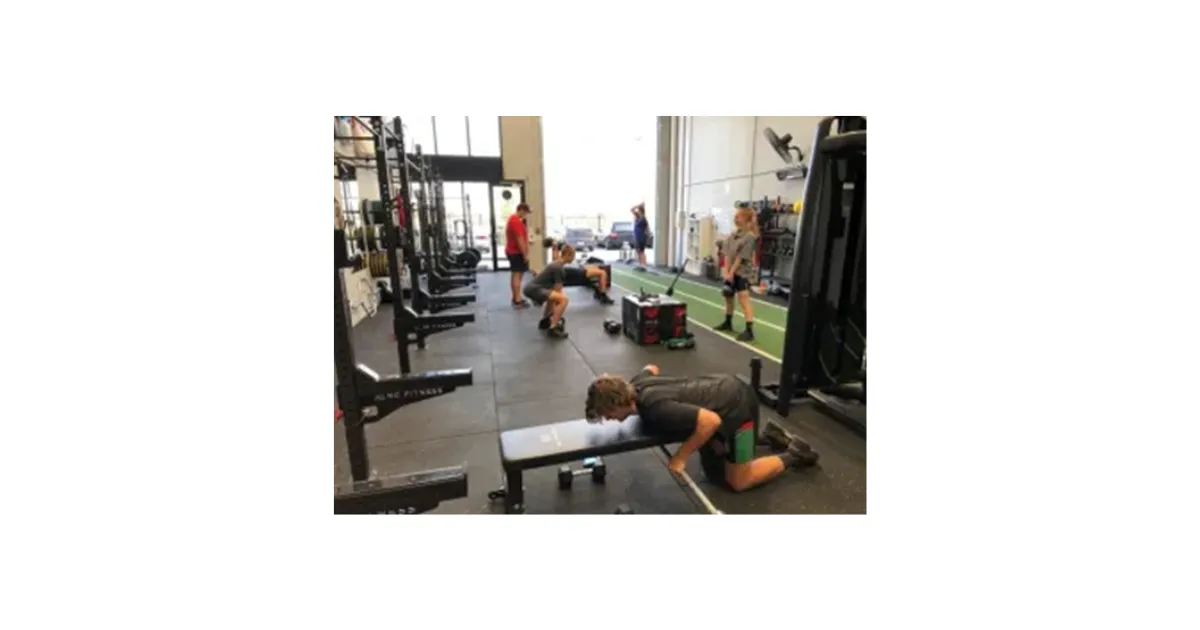 Teenagers training in a small gym supervised by Inner Athlete