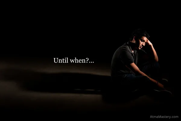 Man sitting alone in a dimly lit space, deep in thought, with the words 'Until when?...' displayed beside him, symbolizing introspection and a call for self-reflection. AtmaMastery.com watermark is present in the bottom corner.