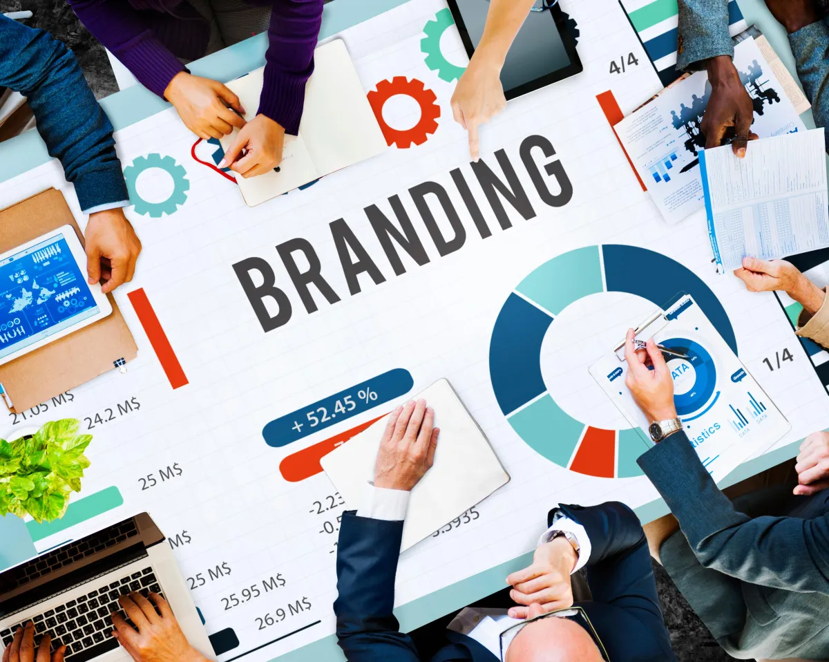 People working on a white board with various marketing images. 