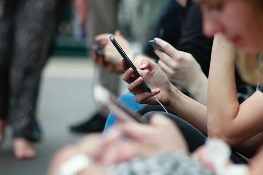 People looking at their cell phones. 