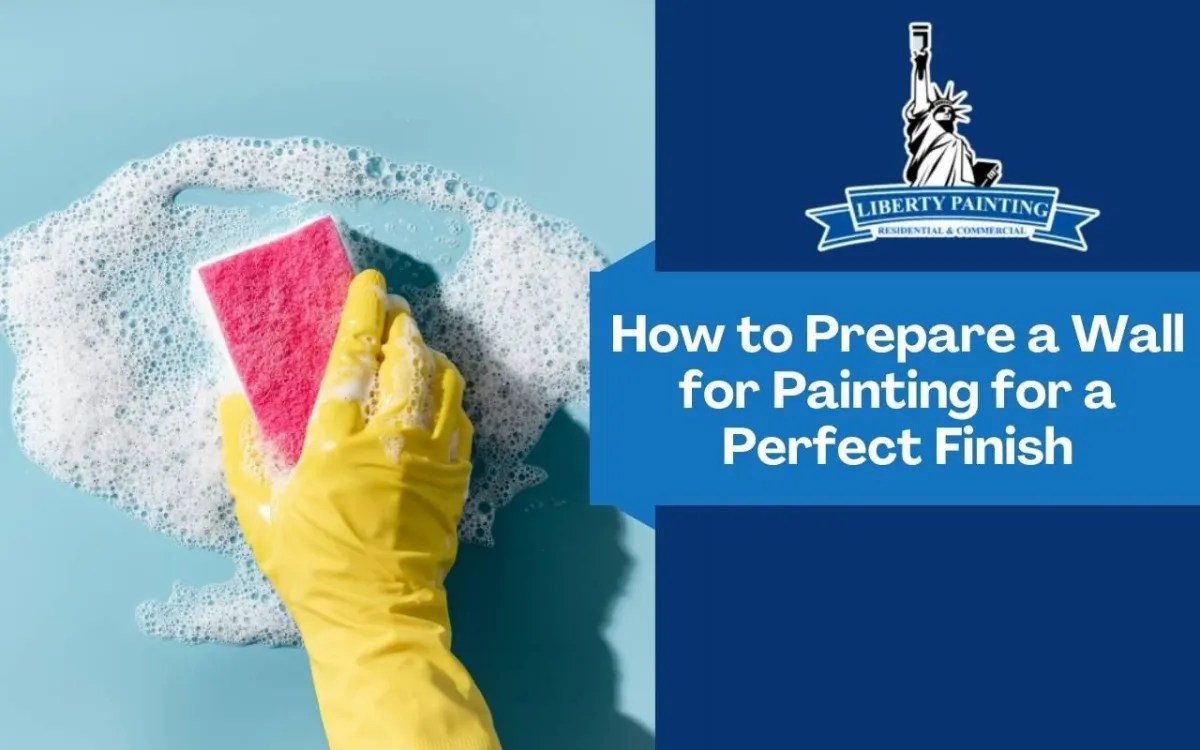 Homeowner wiping a wall clean with a sponge before painting