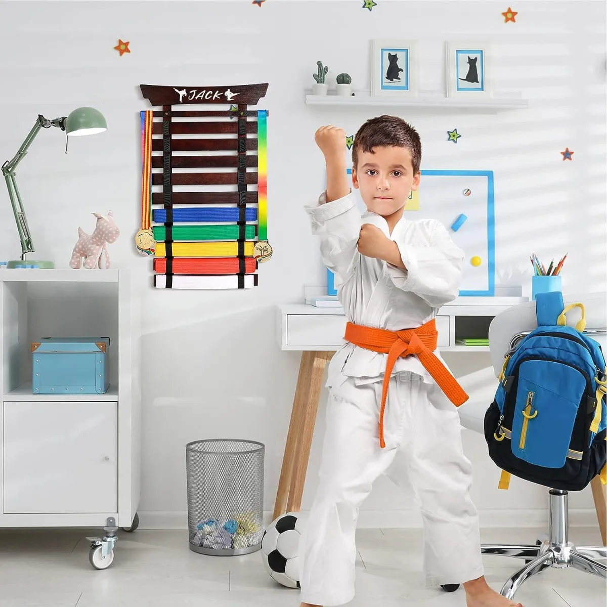 Child holding a martial arts belt with textbooks in the background.