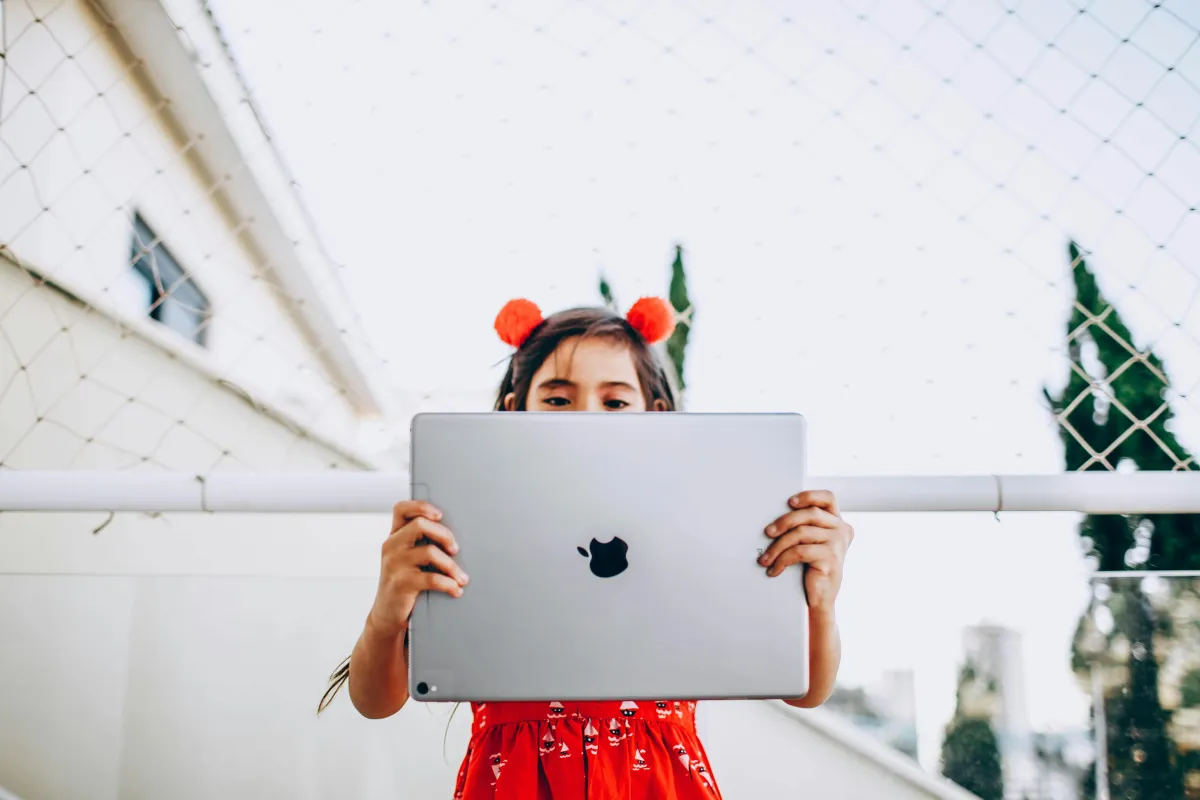 kid with iPad ready to learn