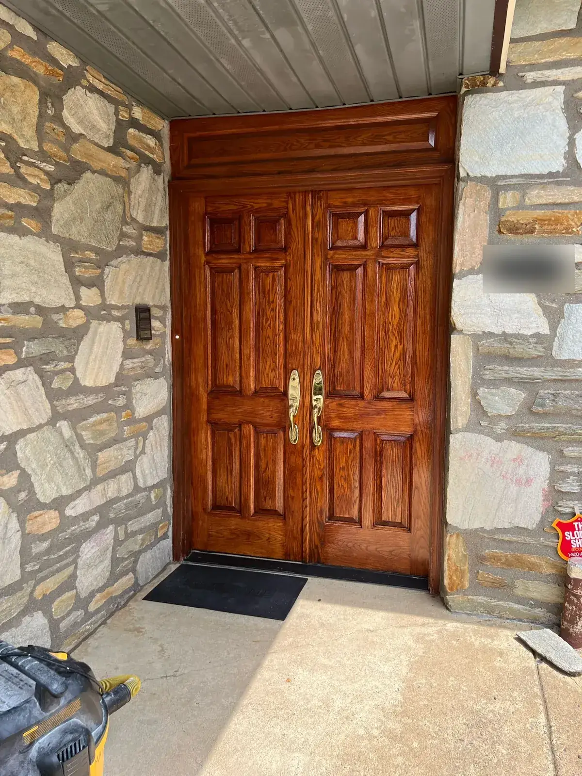 Refinished double entry doors on a stone house