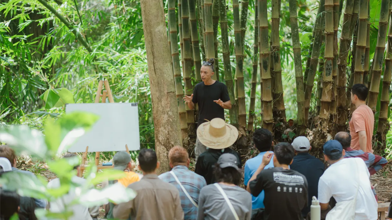 Bamboo expert teaching a group in the bamboo grove at Bamboo U in Bali
