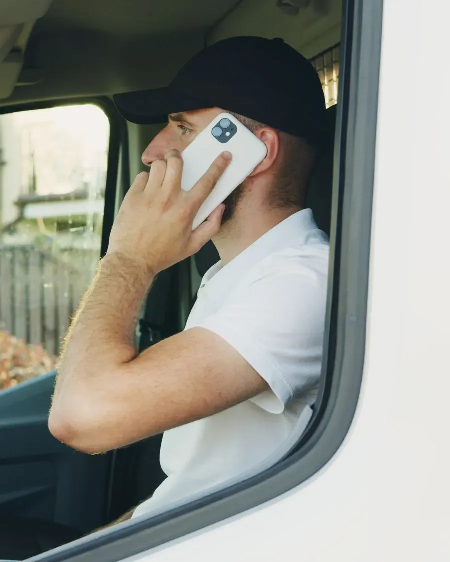 A man in his van on the phone