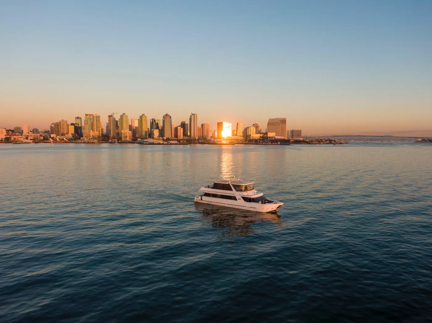 BowTie 80ft luxury yacht at sunset with the San Diego skyline