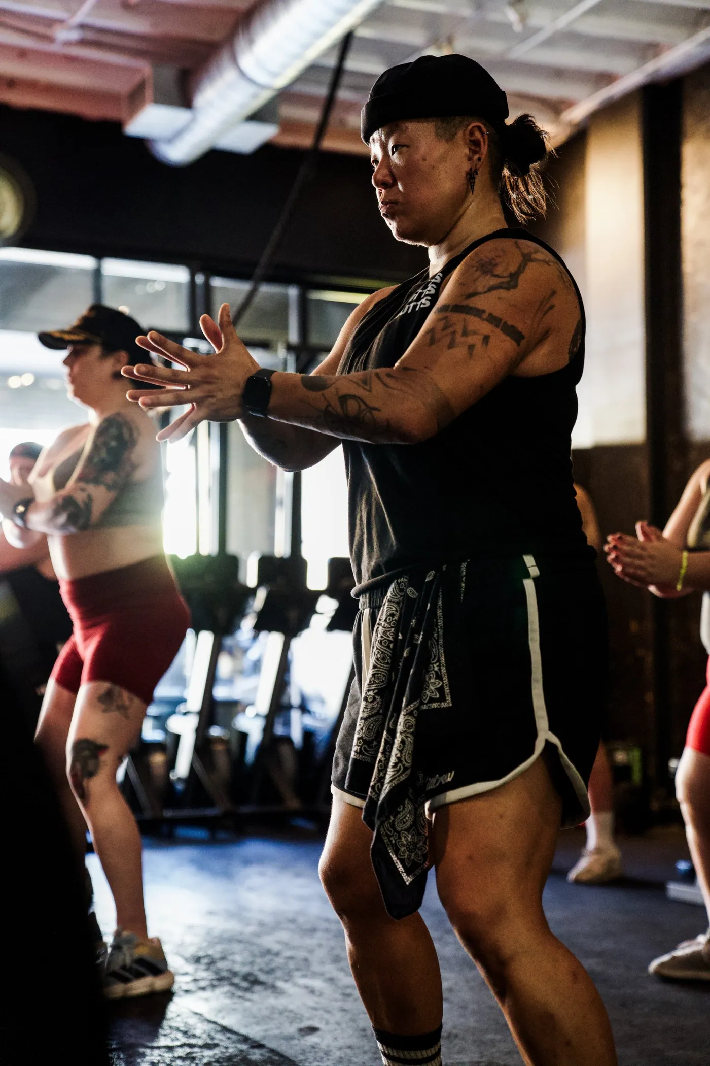 Kai Kim, TPE coach and personal trainer, coaching a strength class