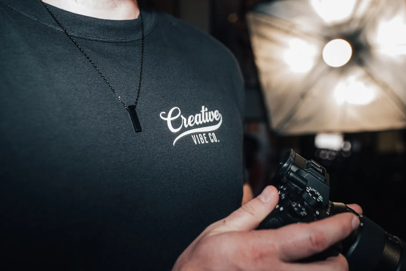 Creative Vibe tee and camera under a softbox
