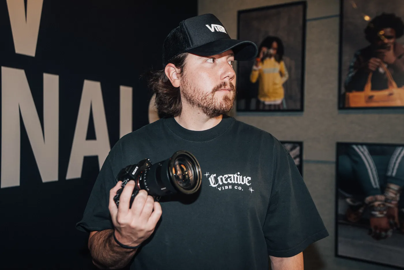 Creative Vibe crew member holding a cinema camera by the ATLFW Originals wall