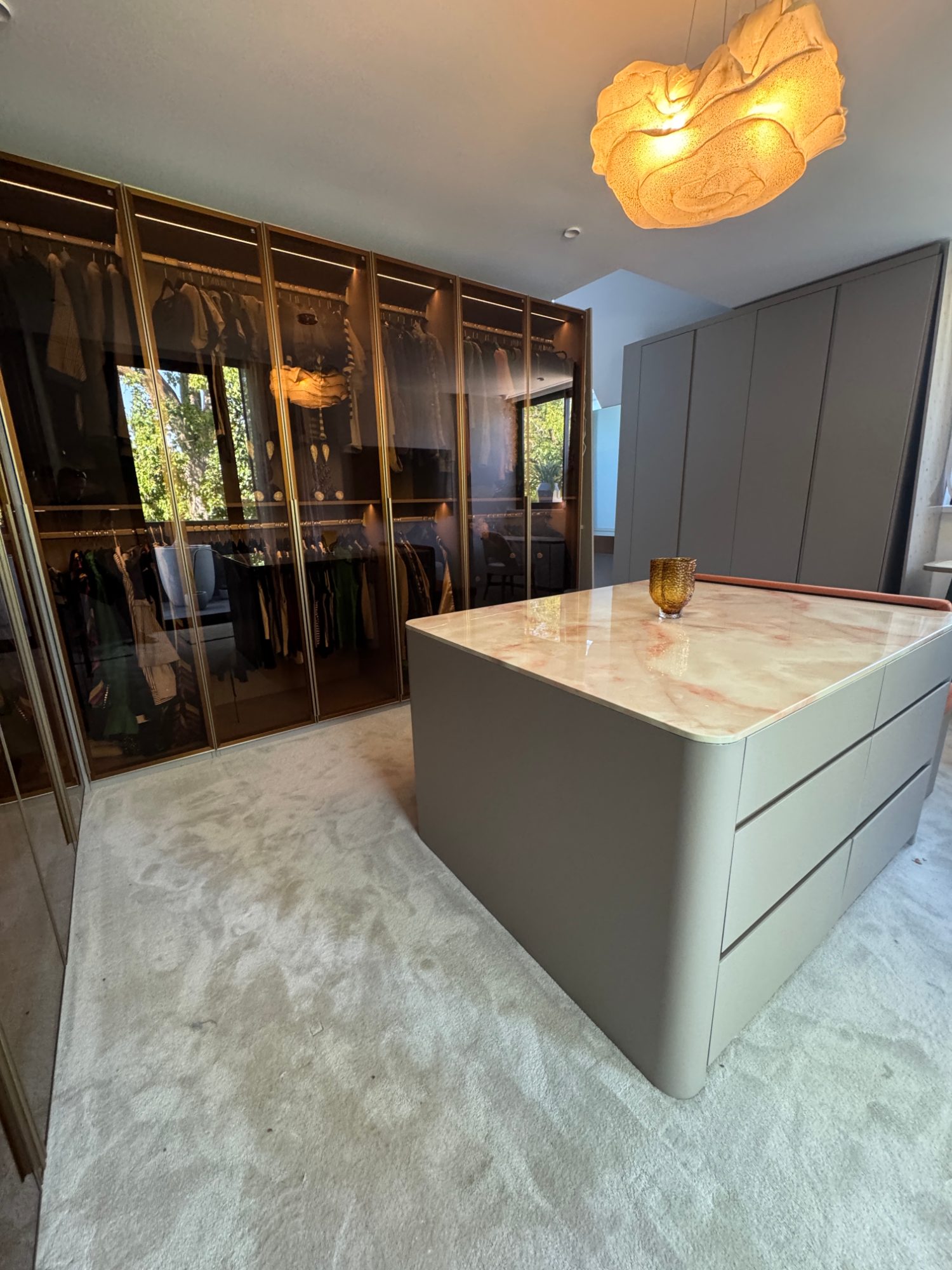 Smoked-glass walk-in robe with stone island