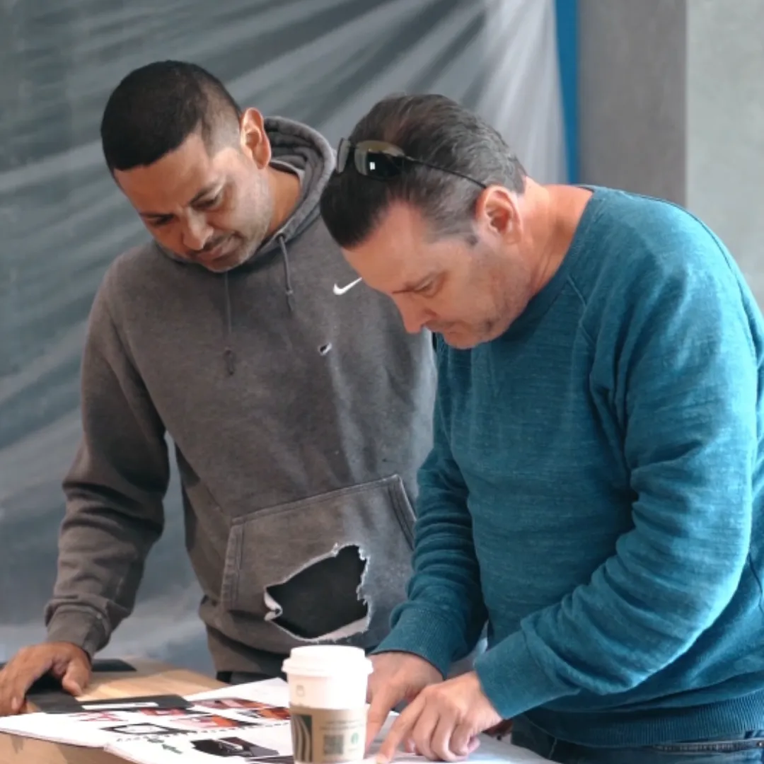 Lior Golan reviewing drawings at the table with a member of the Prestige team