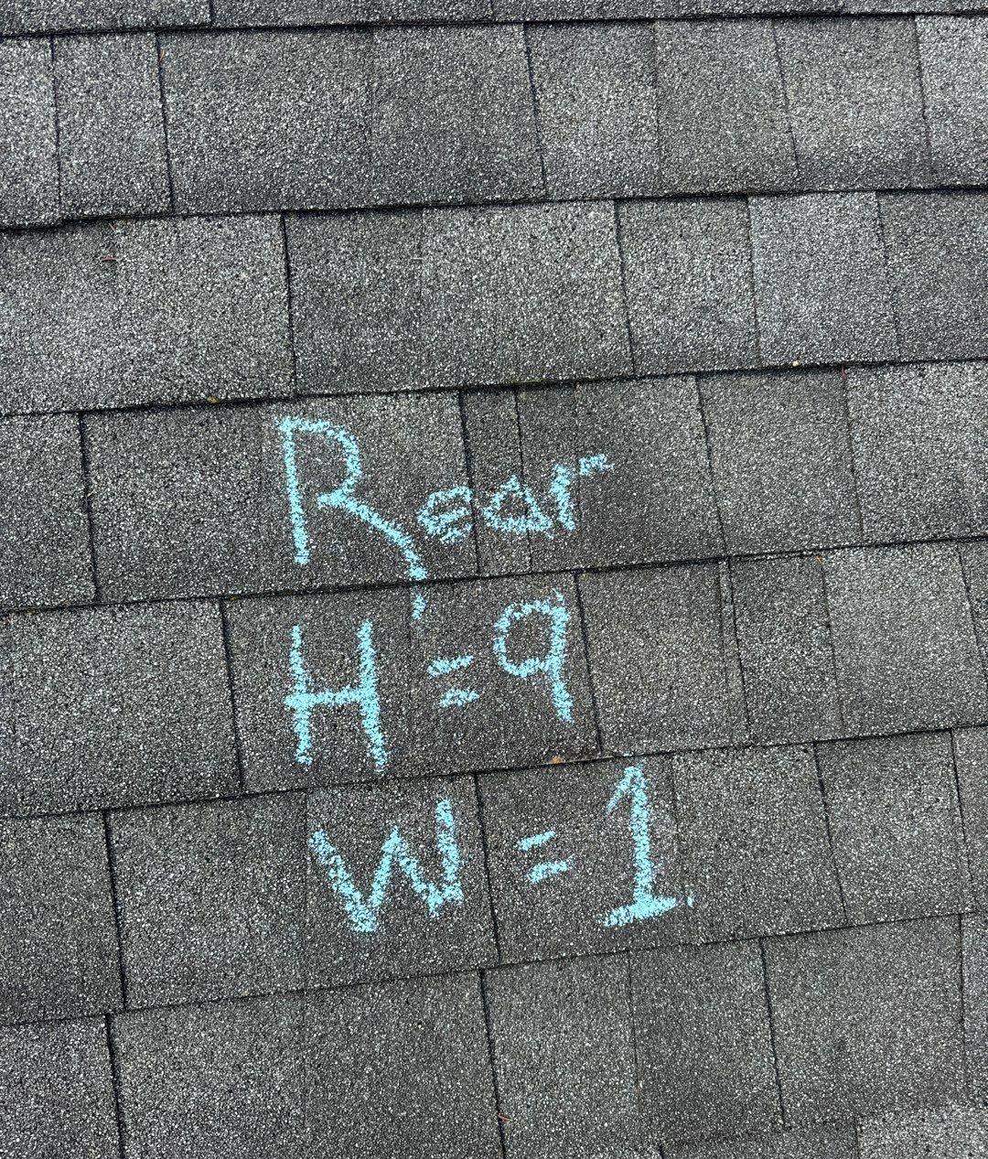 Gray shingles with chalk writing reading Rear, H=9, W=1 inside a test square