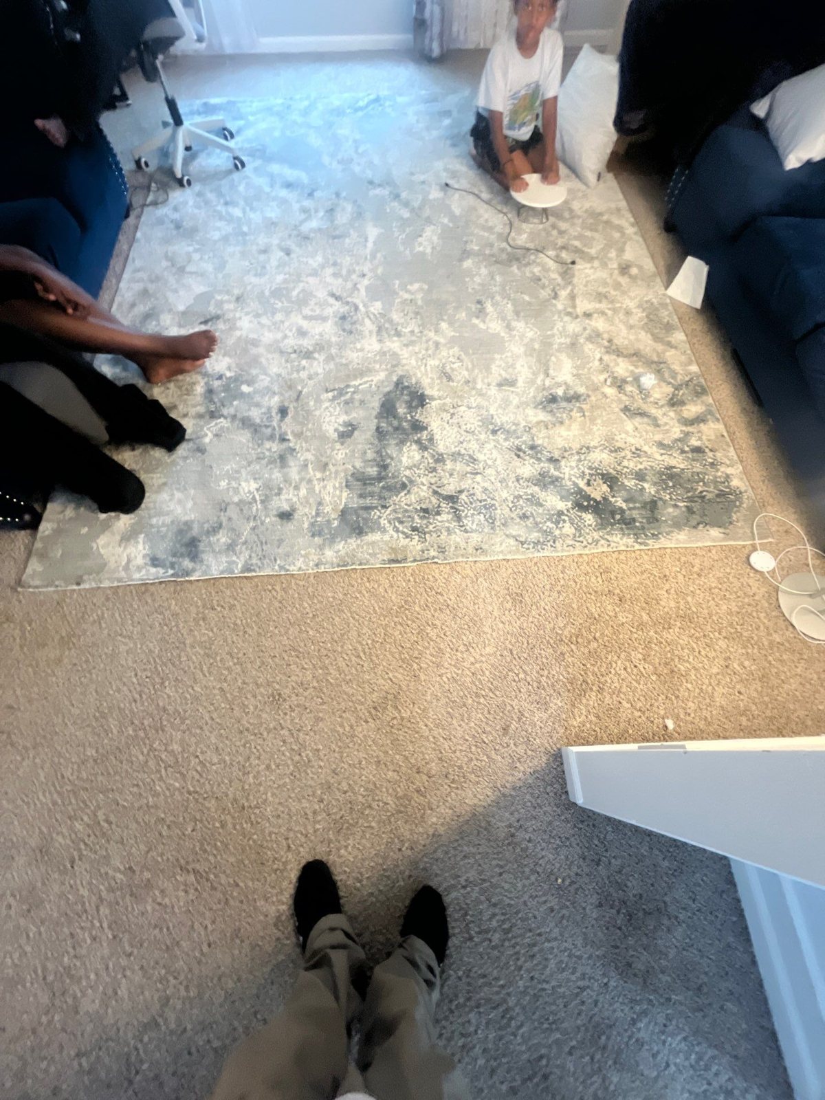 Floor with old covering pulled up, showing the bare subfloor next to carpet