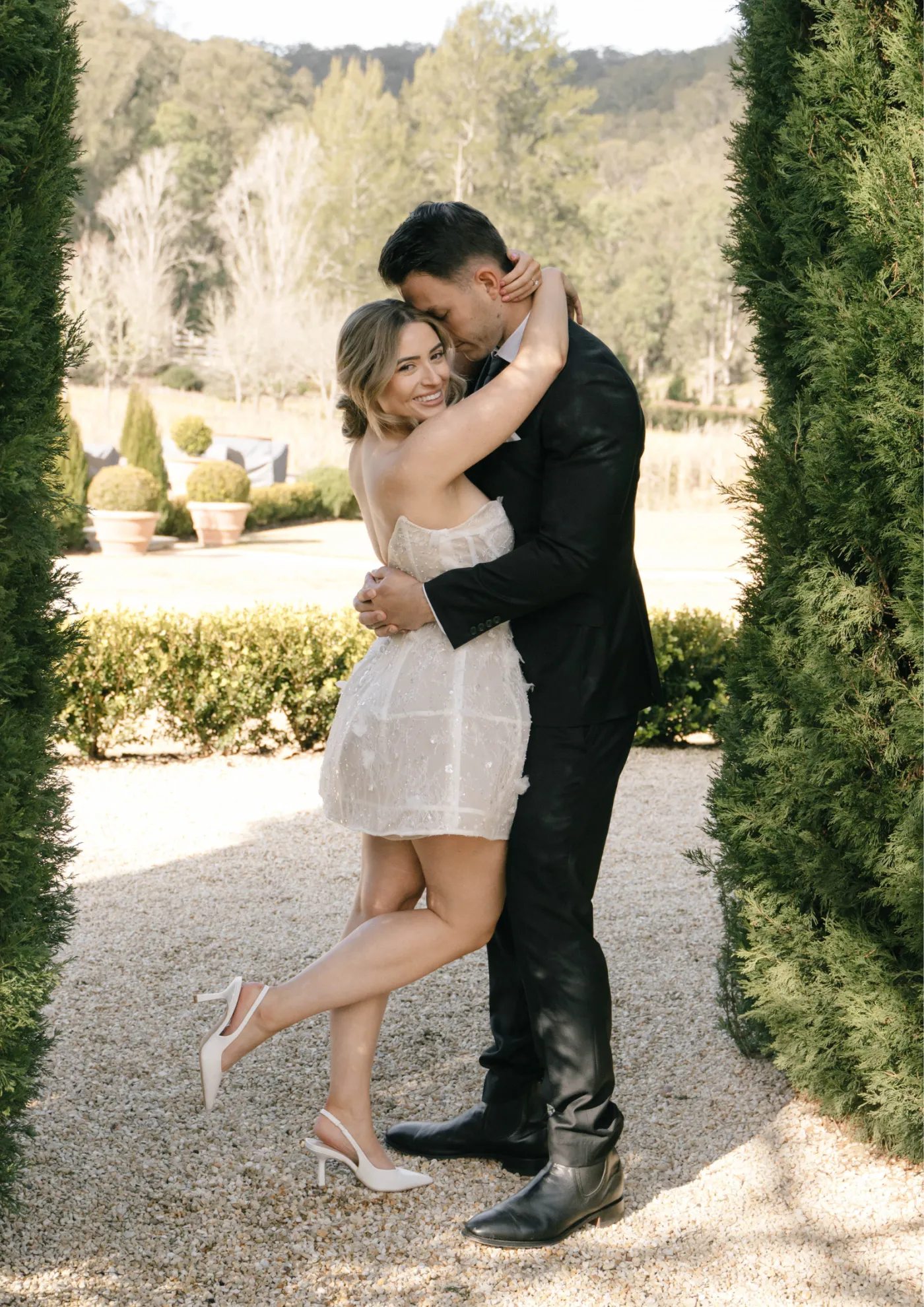 Bride and groom sharing a kiss in the garden