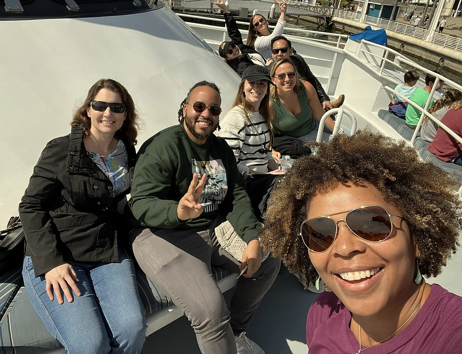 Renaissance Club members smiling together on a harbor boat ride