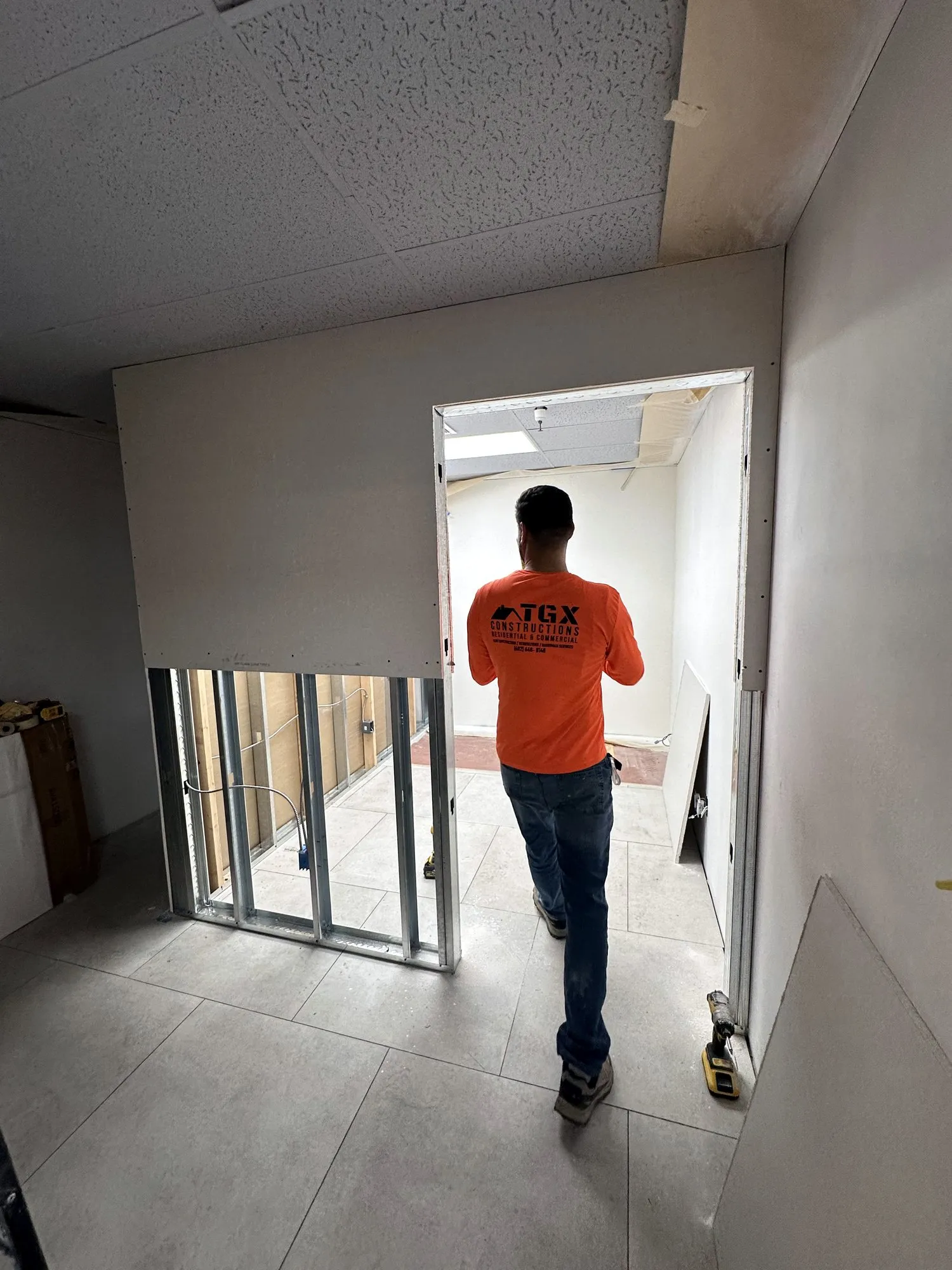 TGX crew walking a stone and tile showroom build-out in Phoenix