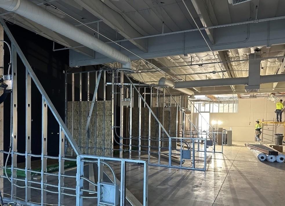Metal stud framing and wall build-out at an indoor golf facility
